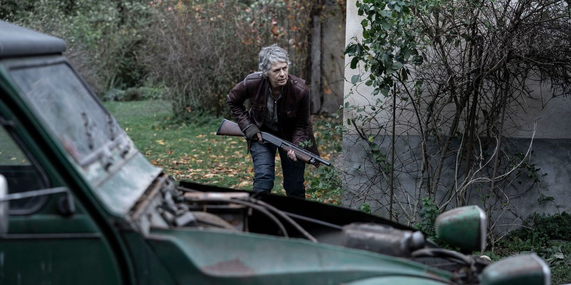 Carol (Melissa McBride) sneaks around a house with a shotgun in 'The Walking Dead: Daryl Dixon'