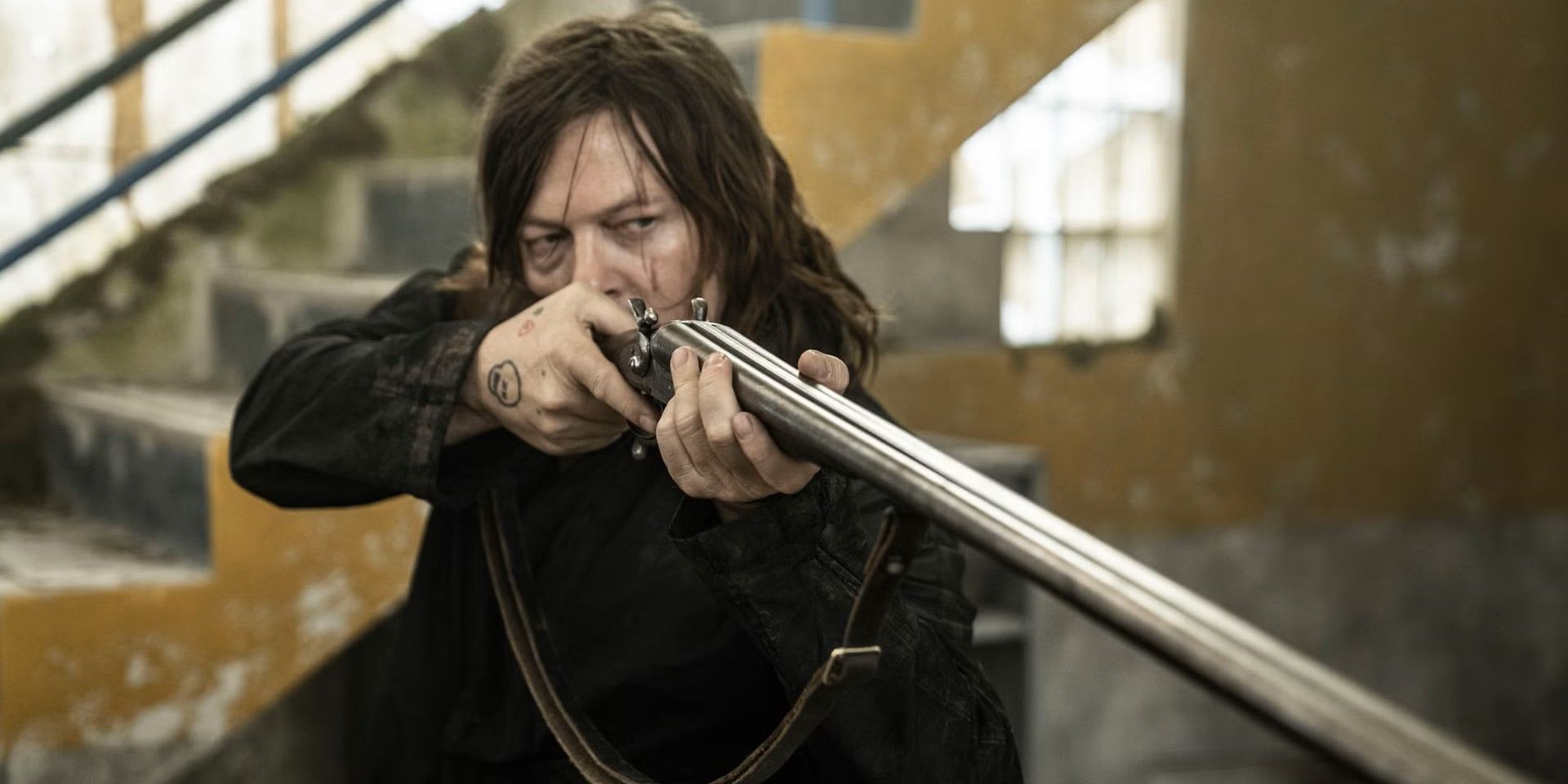 Daryl Dixon (Norman Reedus) points a gun in 'The Walking Dead: Daryl Dixon - The Book of Carol' episode "Moulin Rouge".