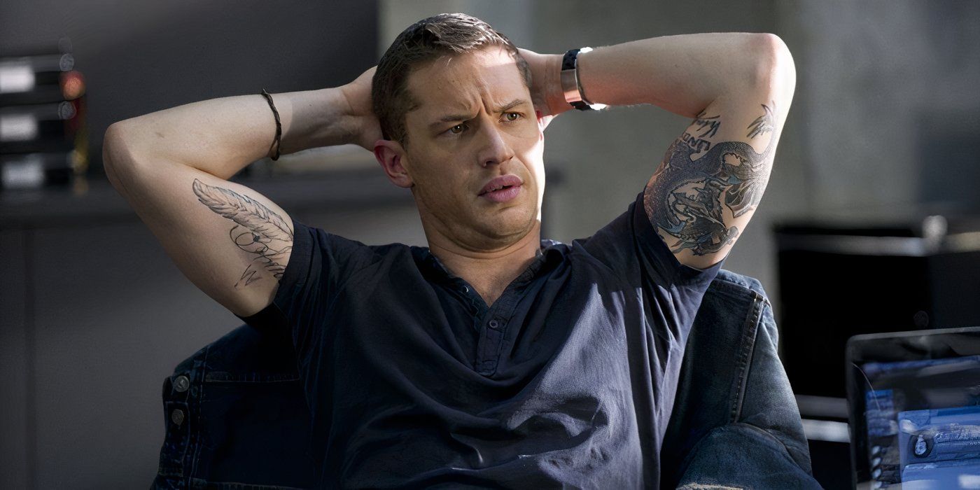 Tom Hardy leans back in a chair, showing off his tattoos, while looking confused in 'This Means War'