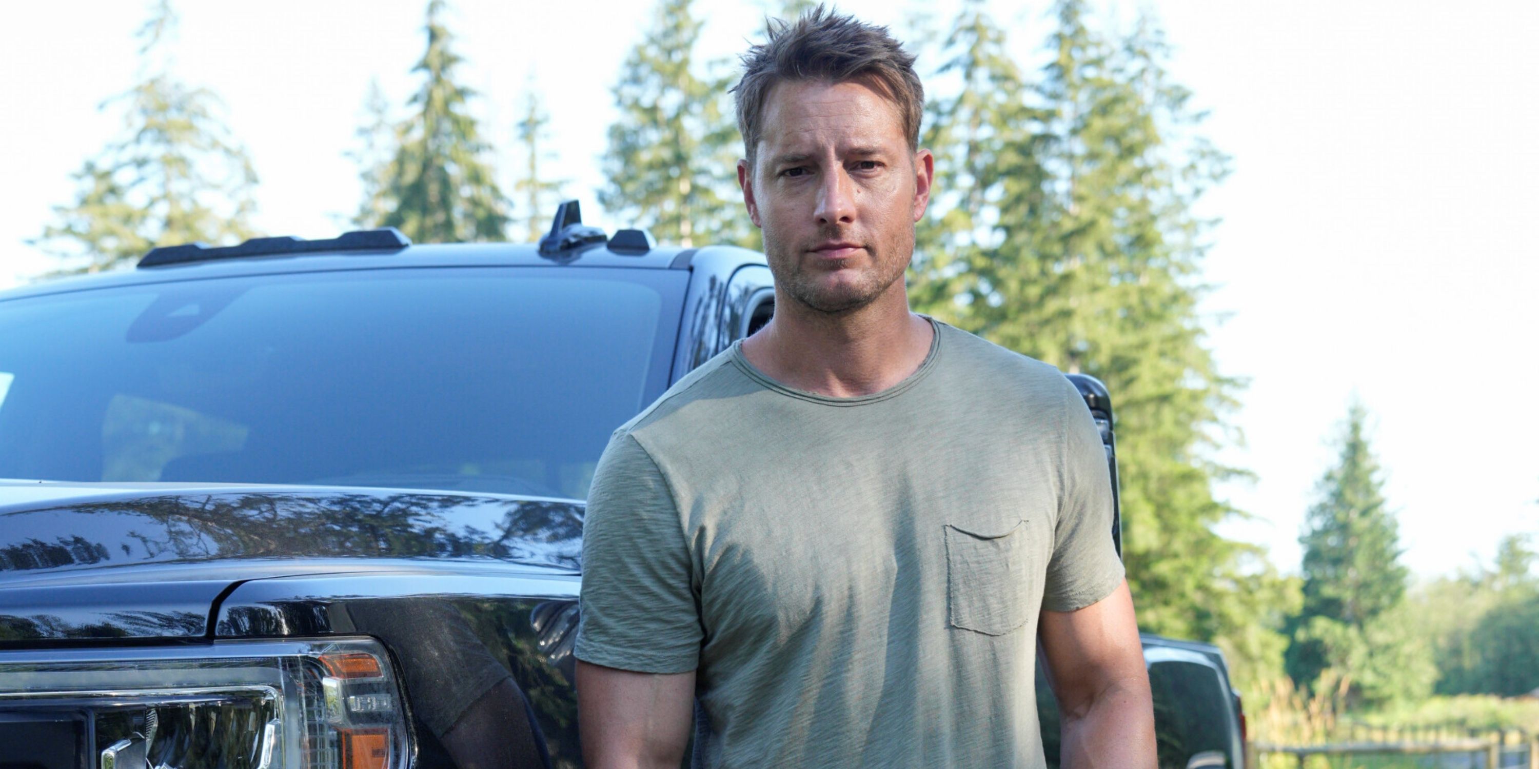 Justin Hartley as Colter Shaw standing in front of a big black truck in Season 2 of Tracker