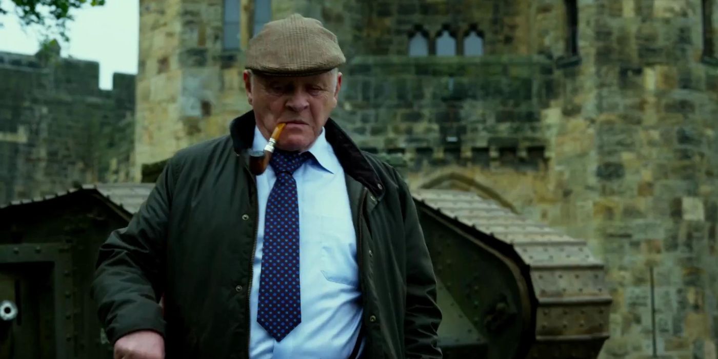 Sir Edmund Barton (Anthony Hopkins) walks out of a castle smoking a pipe in 'Transformers: The Last Knight' (2017).