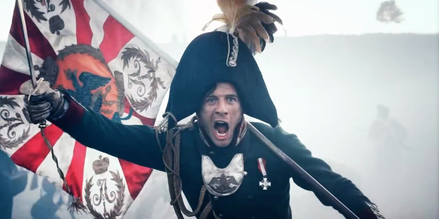 James Norton holding a sword and a flag during a battle in 'War and Peace.'