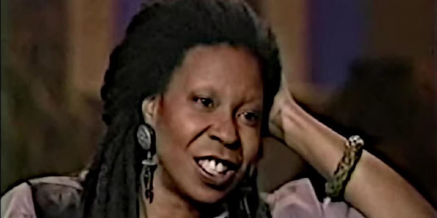 Host Whoopi Goldberg smiles, leaning her head on her hand on The Whoopi Goldberg Show.