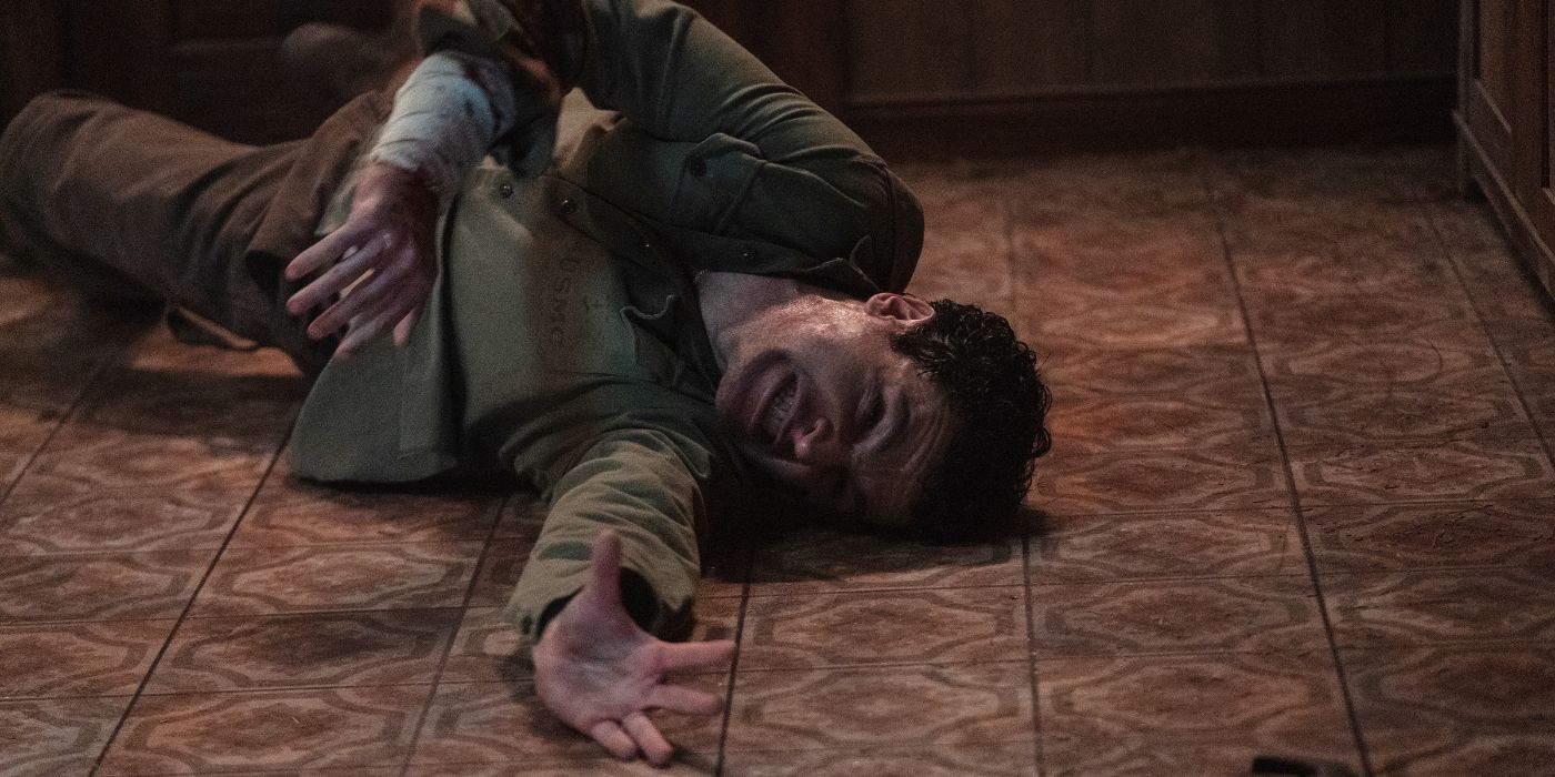 Christopher Abbott convulsing on the floor as Blake in Wolf Man.