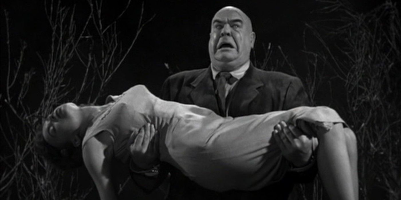 The zombified Inspector Clay, played by actor Tor Johnson, carries an unconscious Paula, played by actor Mona McKinnon, in Plan 9 from Outer Space.