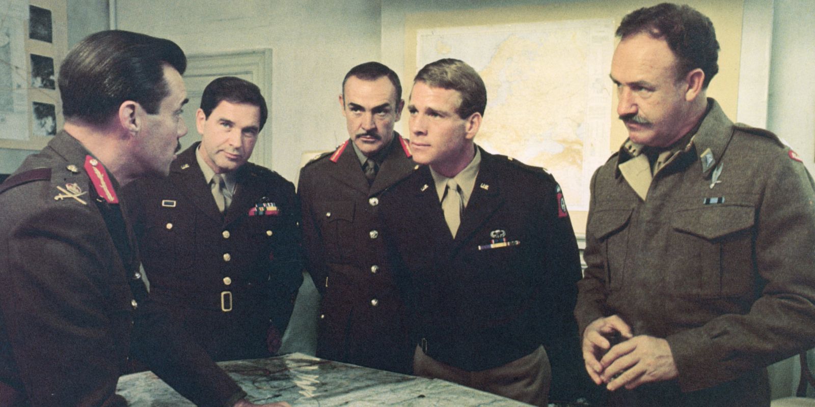 Ensemble cast of a A Bridge Too Far standing over a map discussing strategy