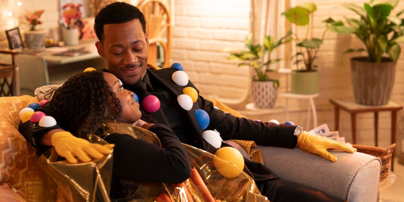 Quinta Brunson and Tyler James Williams cuddling on the couch