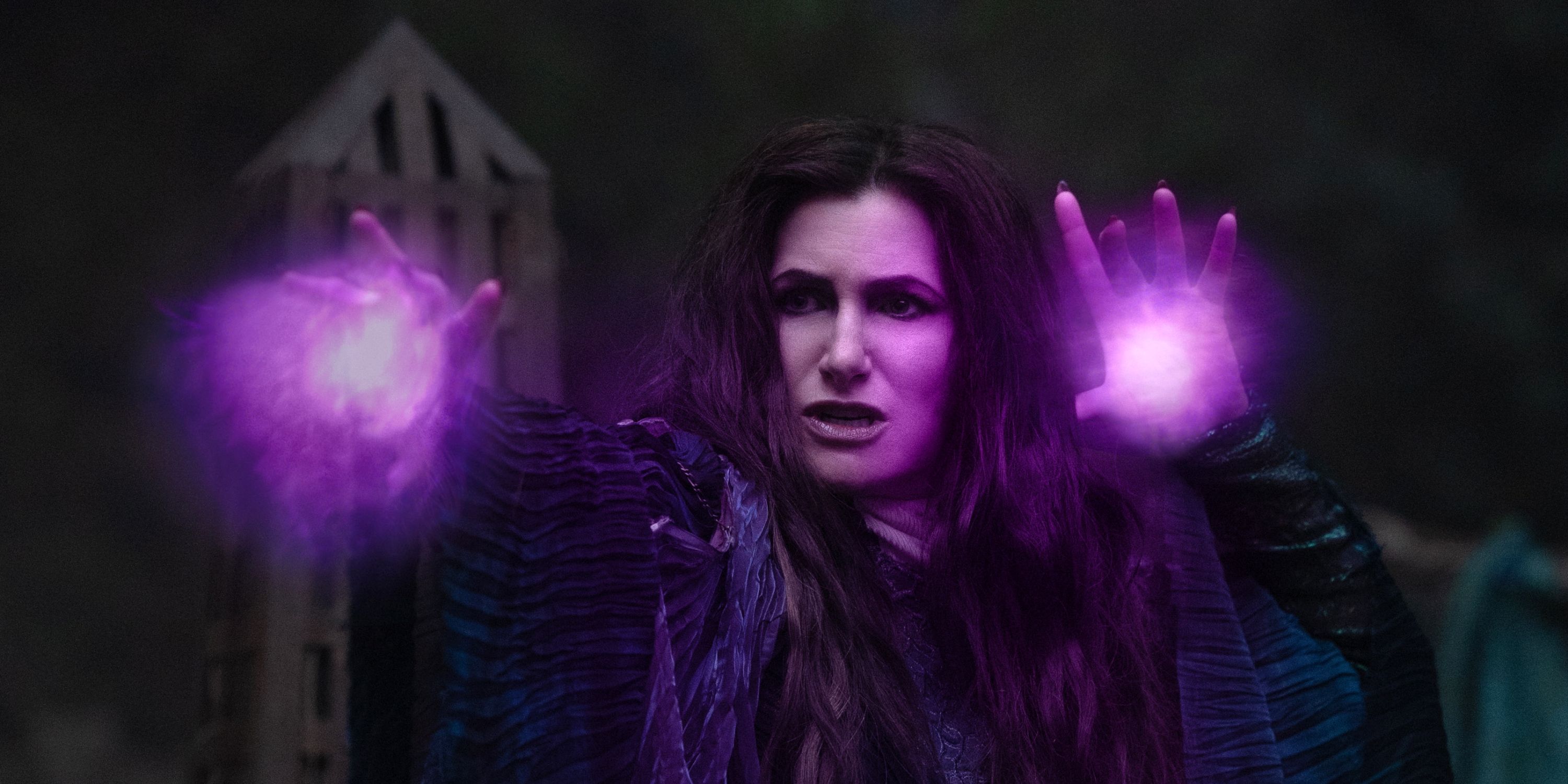 Kathryn Hahn as Agatha Harkness throwing purple light out from her hands in Agatha All Along