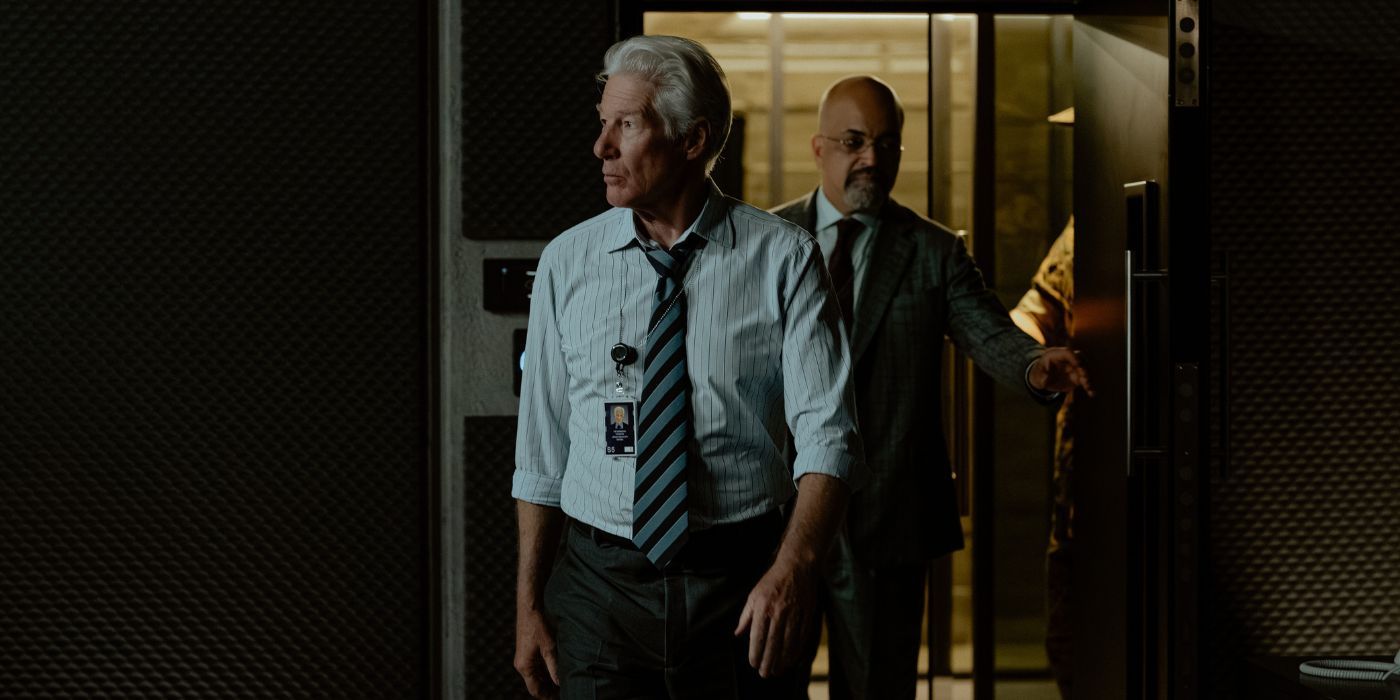 Richard Gere and Jeffrey Wright walking into a dark room in The Agency.