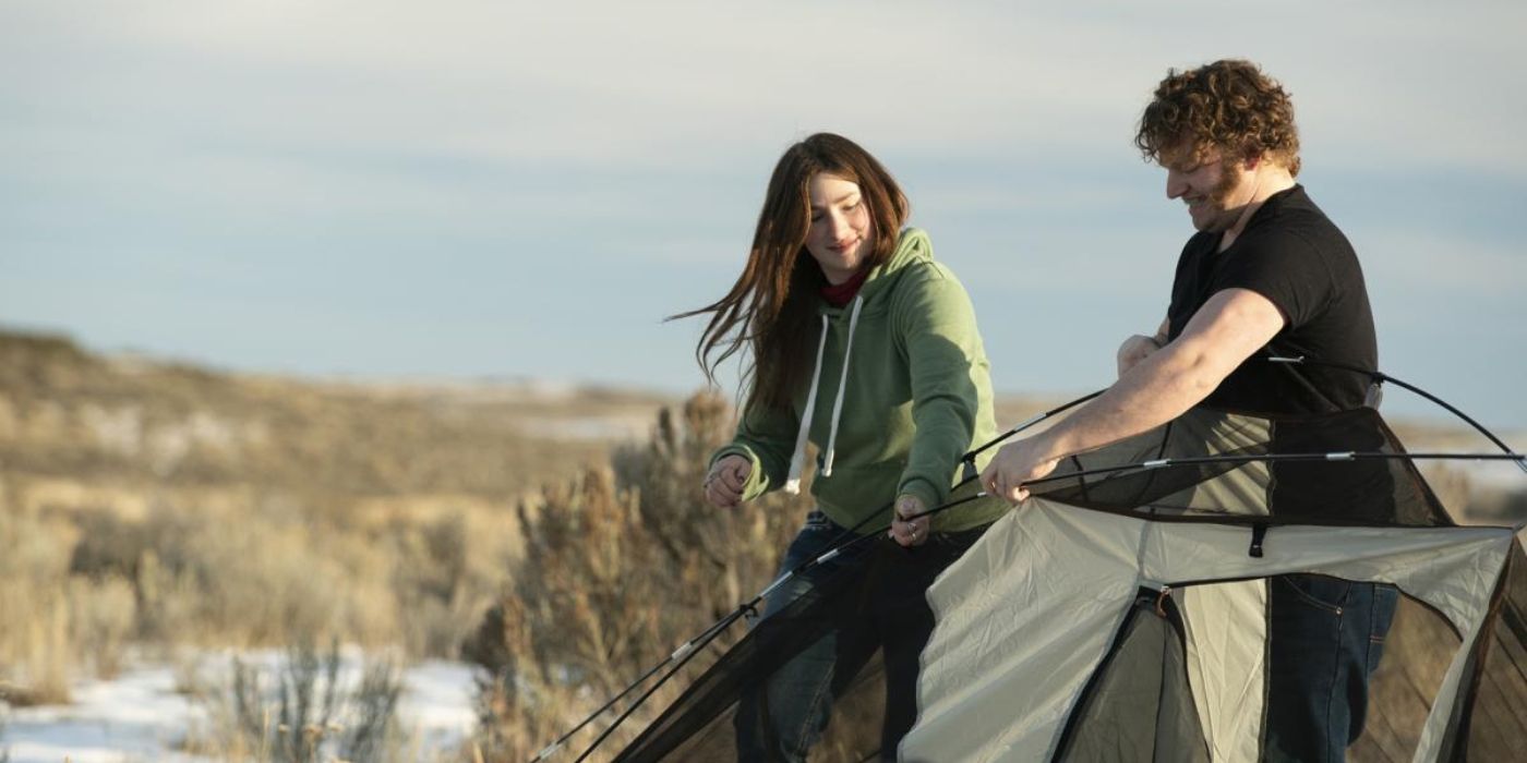 Two people pitch a tent near a grassy area for Thanksgiving on Alaskan Bush People.