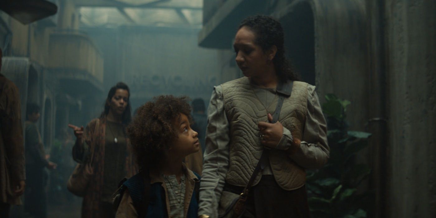 Alexandria Riley, walking with her son, as Camille Sims in Silo Season 2