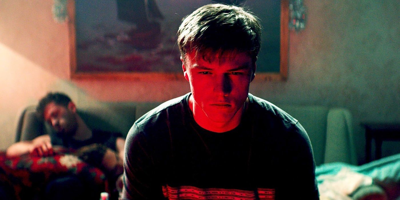 Sam Gittins as Nick Milgram sitting and staring at the screen in Await Further Instructions