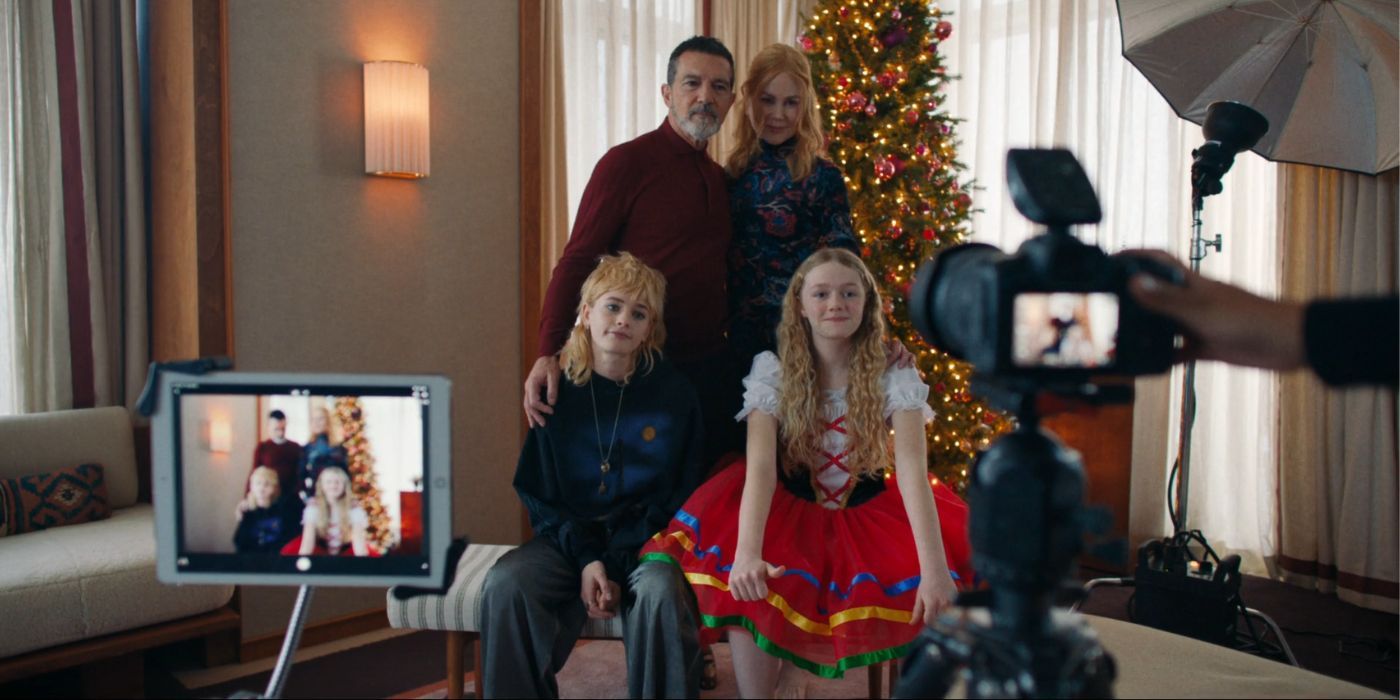 Antonio Banderas, Nicole Kidman, Esther McGregor, and Vaughan Reilly posing for a family photo in front of a Christmas tree in Babygirl.