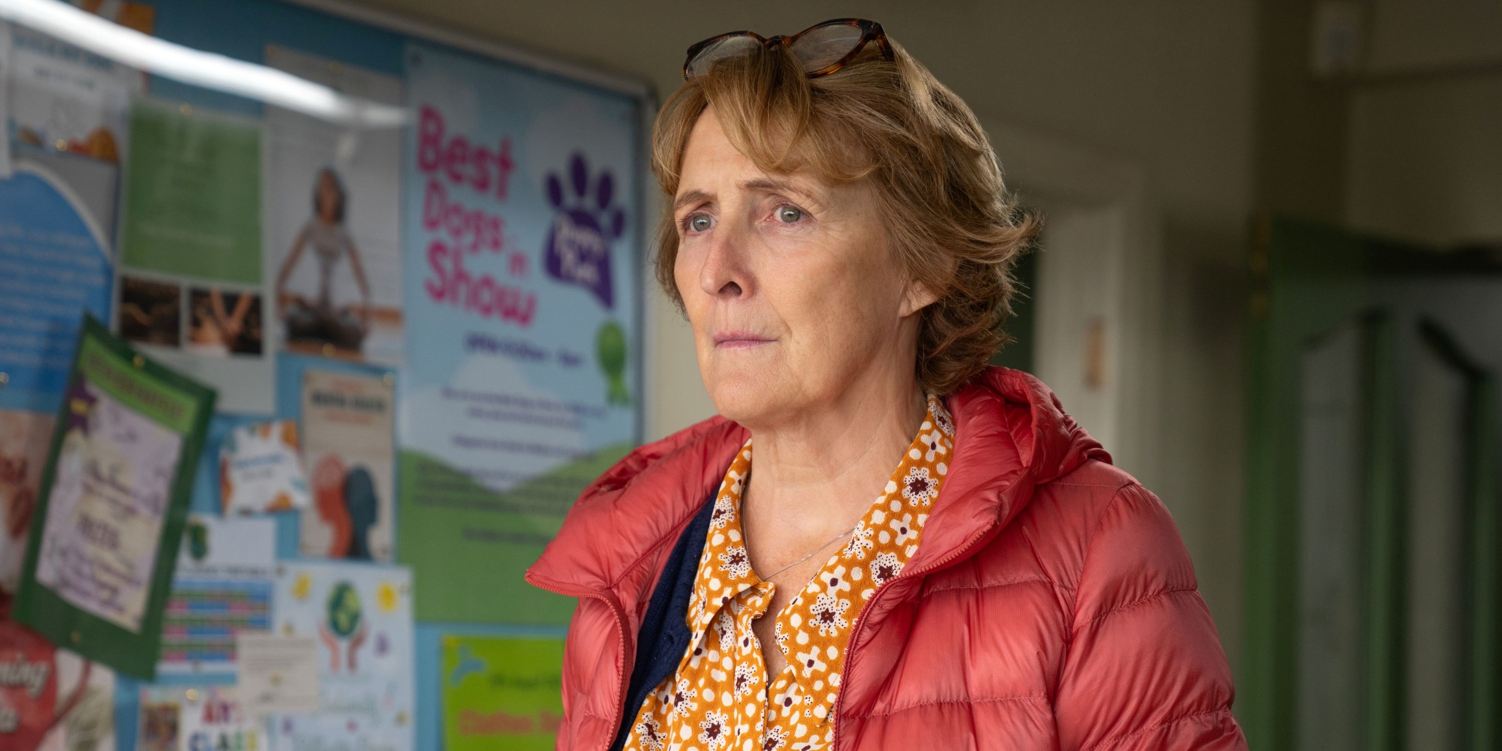 Fiona Shaw as Angelica Collins in a red puffy coat and yellow print button-down shirt in Bad Sisters Seasn 2