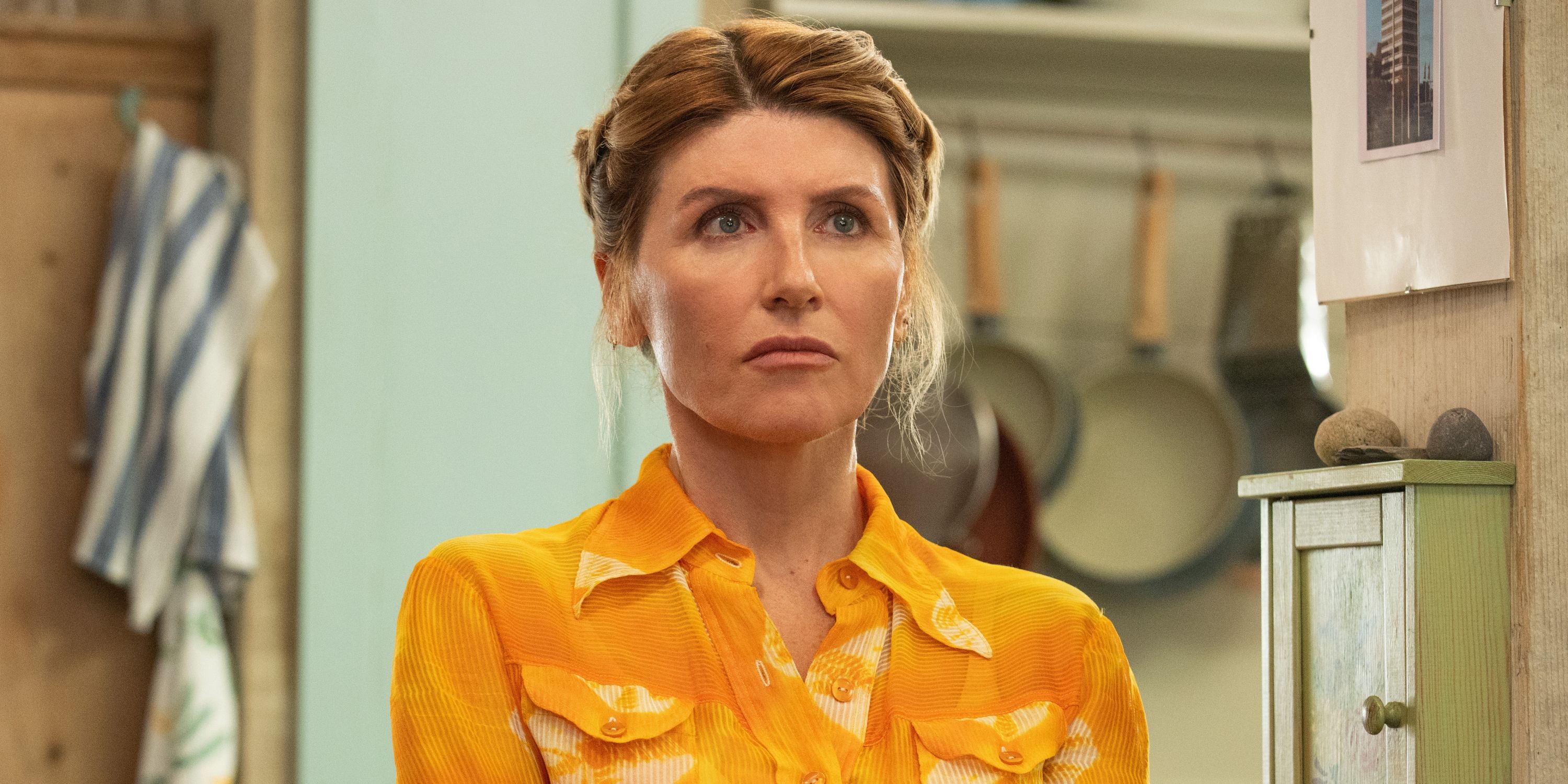 Sharon Horgan as Eva Garvey in a gold blouse with her hair up in Season 2 of Bad Sisters