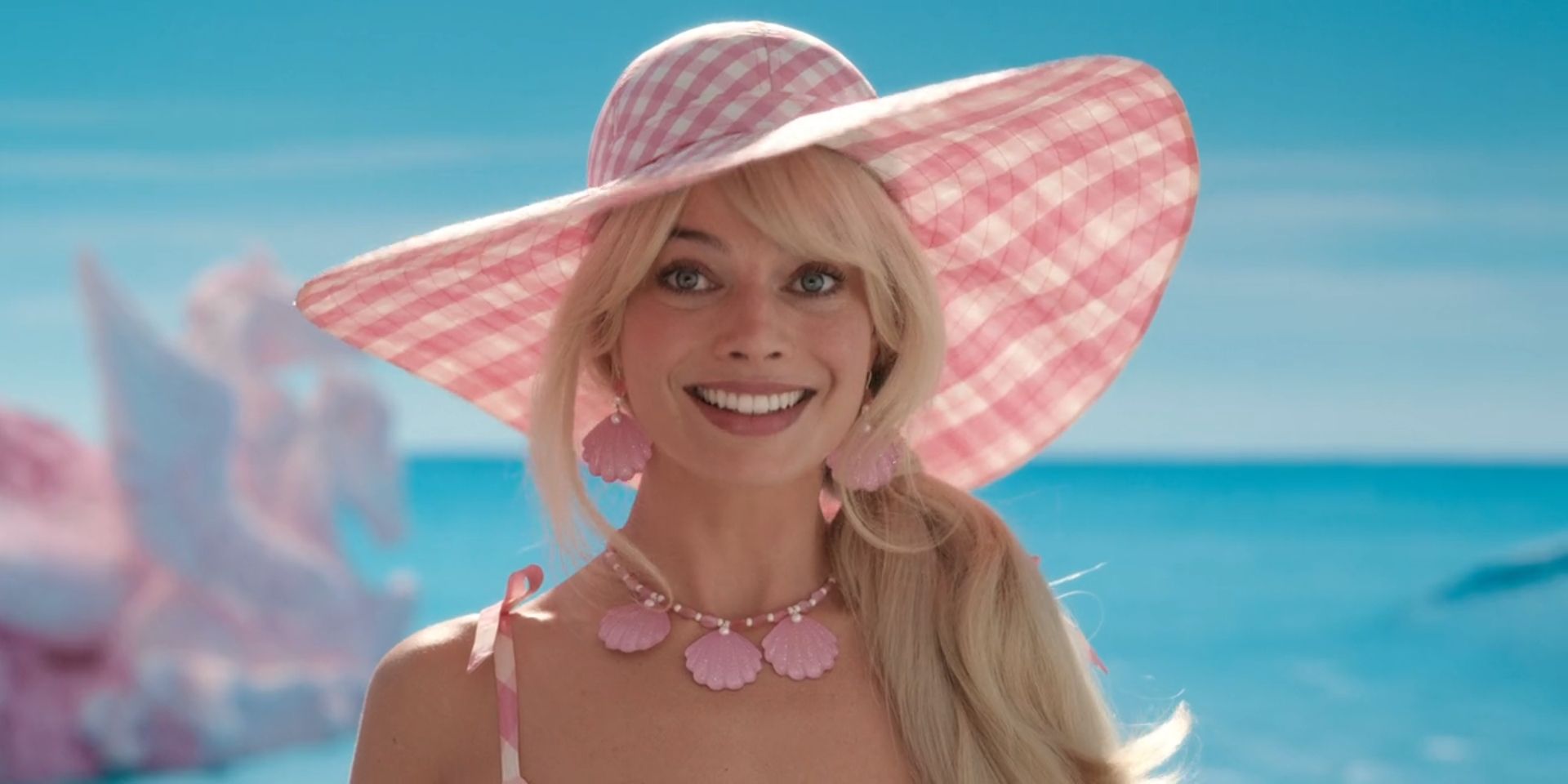 Barbie, played by Margot Robbie, smiles in 'Barbie'.