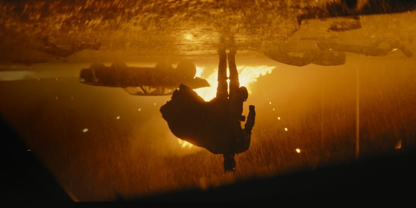 An upside down shot of Batman walking away from fire in The Batman