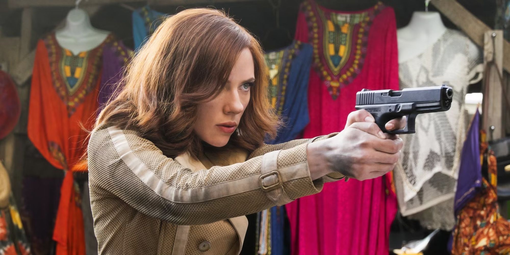 Scarlett Johansson as Black Widow walks with a weapon in a Lagos street market in Captain America: Civil War