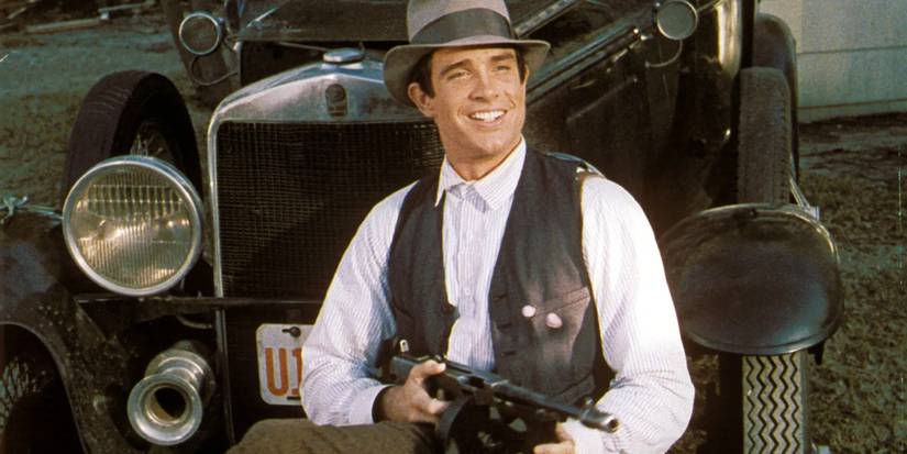 Clyde Borrow smiling while aiming a gun in Bonnie and Clyde