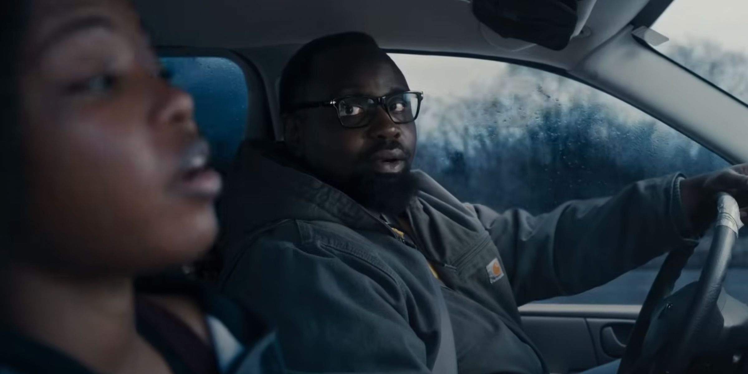 Brian Tyree Henry as Jason driving a car and taking to Ryan Destiny as Claressa in The Fire Inside