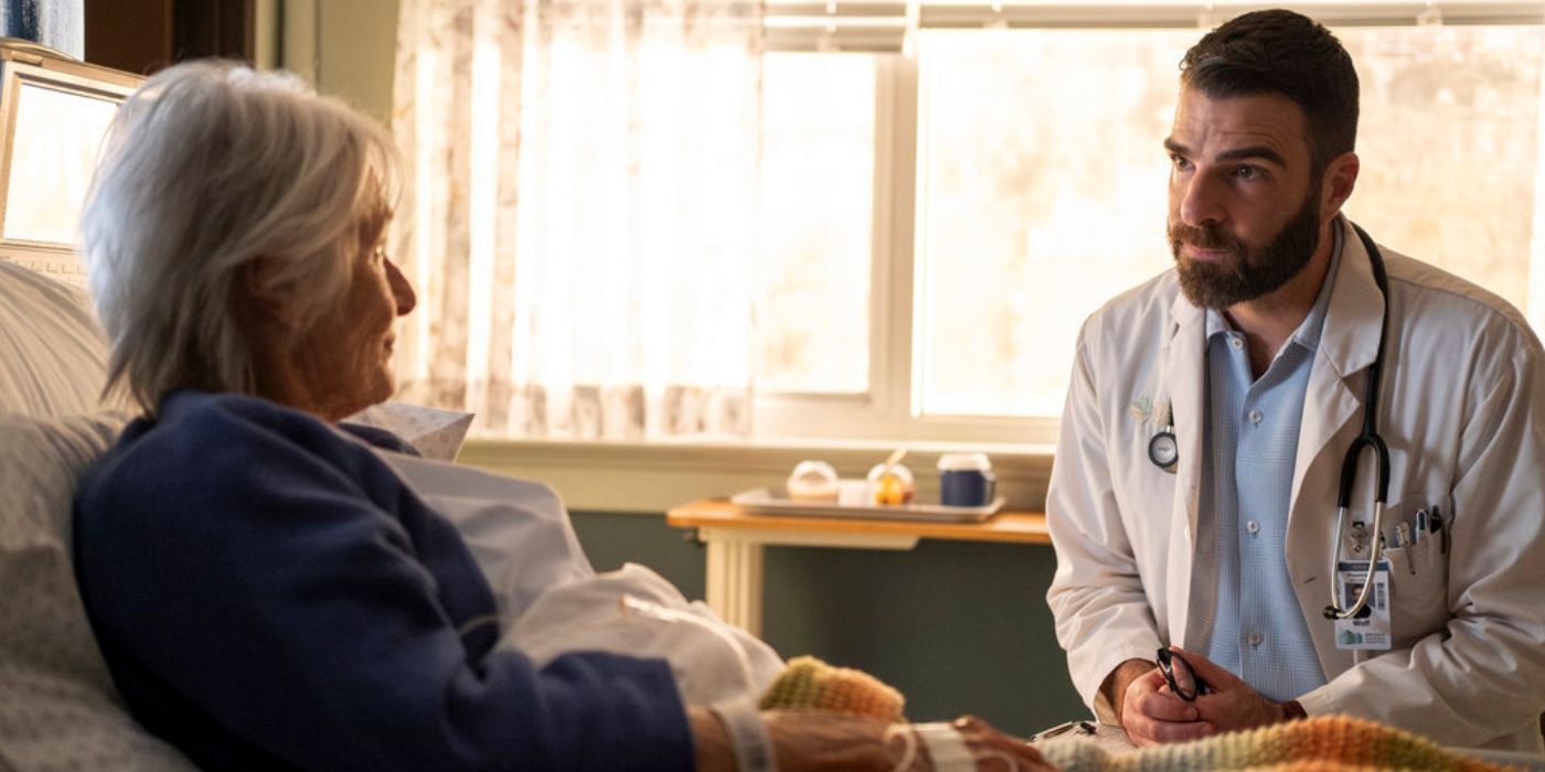 Zachary Quinto as Dr. Oliver Wolf sitting with Susan Nimoy as June in her hospital bed in Brilliant Minds