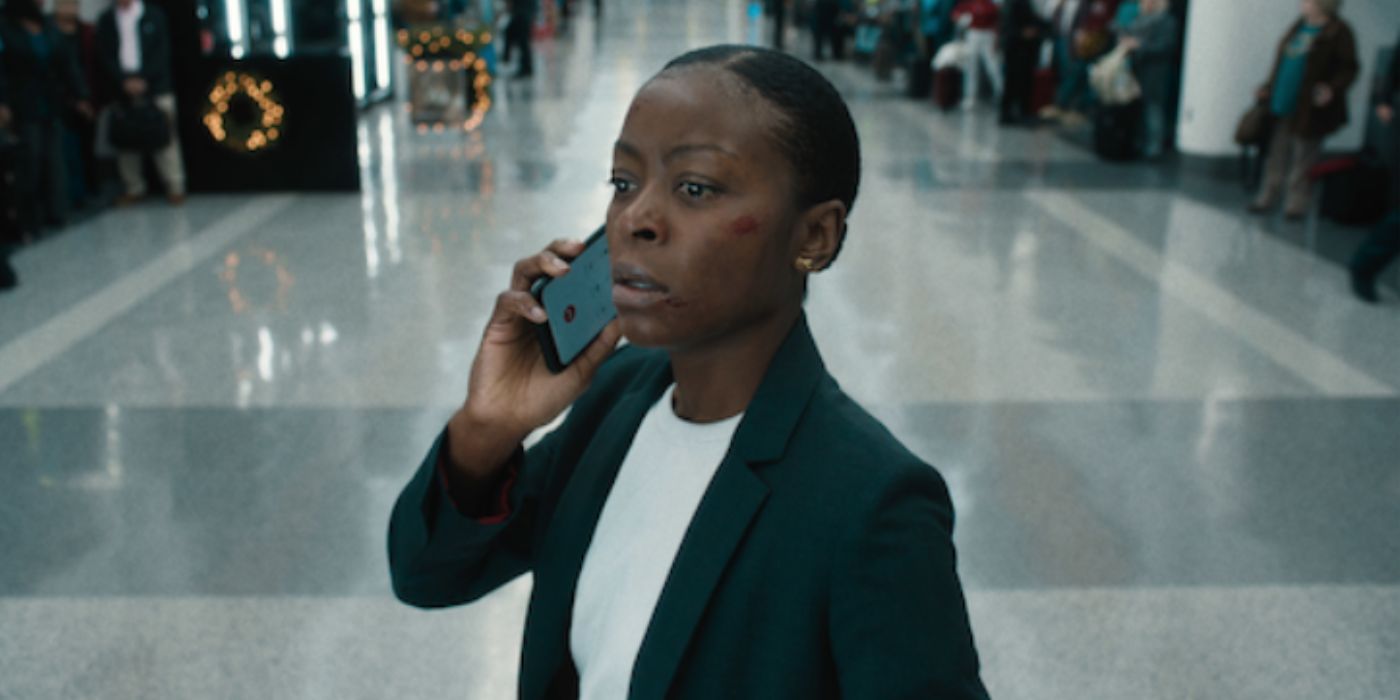 Danielle Deadwyler holding a phone next to her ear with a shocked expression in &lsquo;Carry-On&rsquo;.
