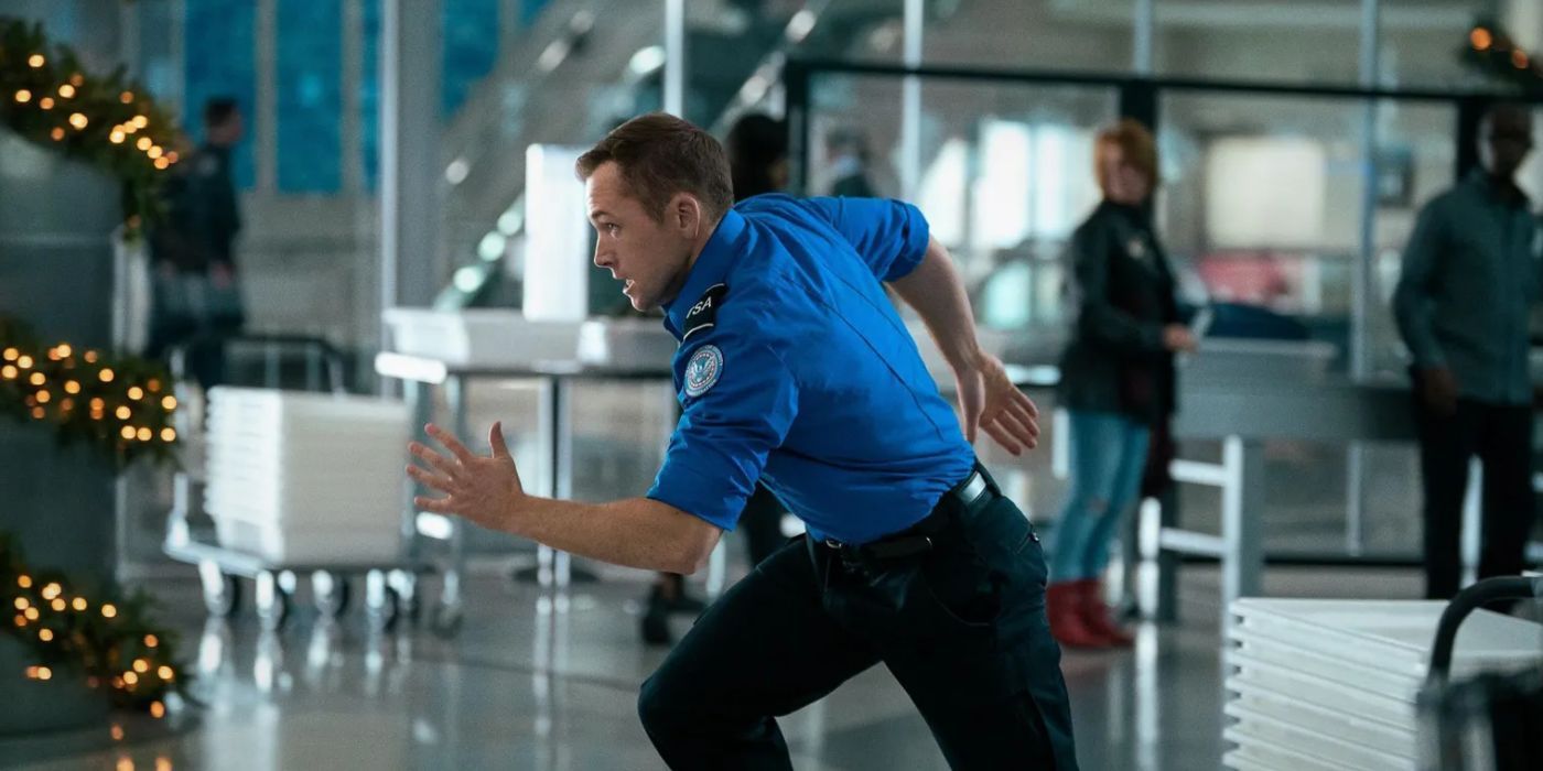 Taron Edgerton running inside an airport in 'Carry-On'.