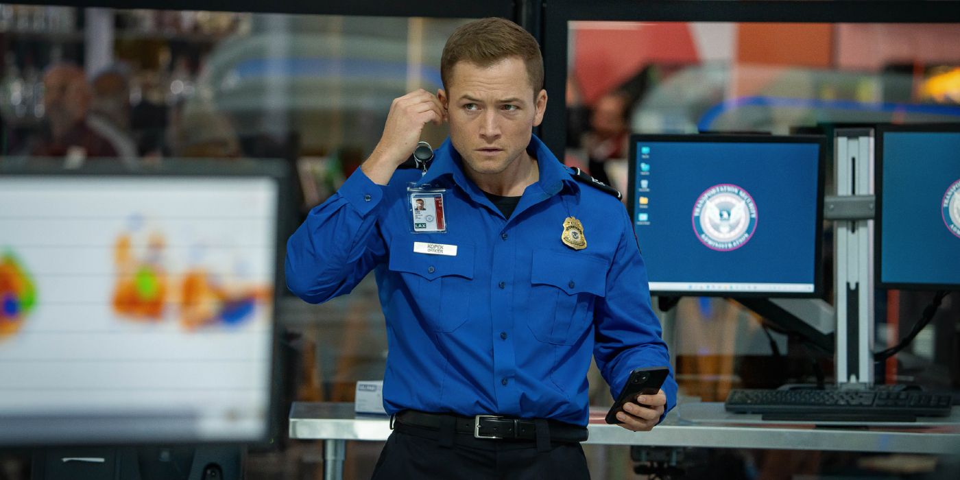 Taron Egerton takes a call as a TSA agent in Carry-On