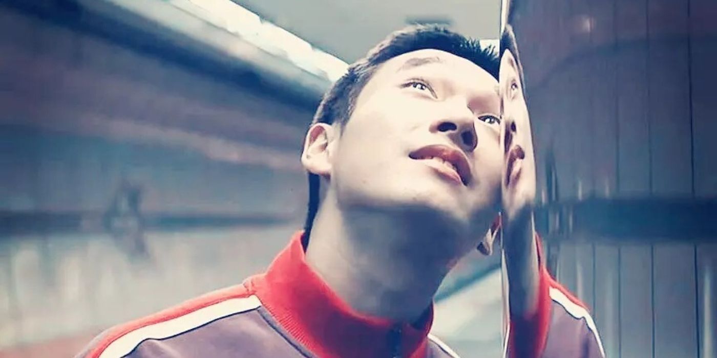A young man&rsquo;s face is reflected in glass as he looks up in Marathon 2005.