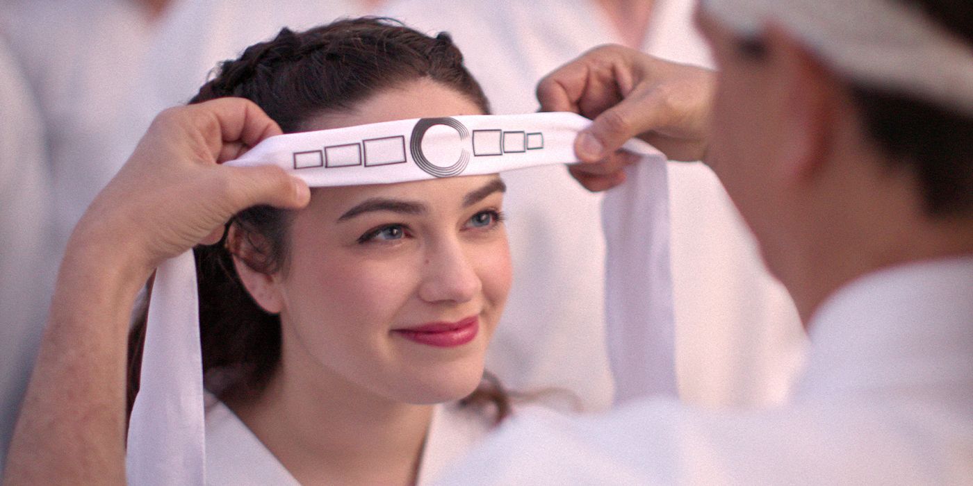 Close-up of Sam (Mary Mouser) smiling as she's being honored with a headband