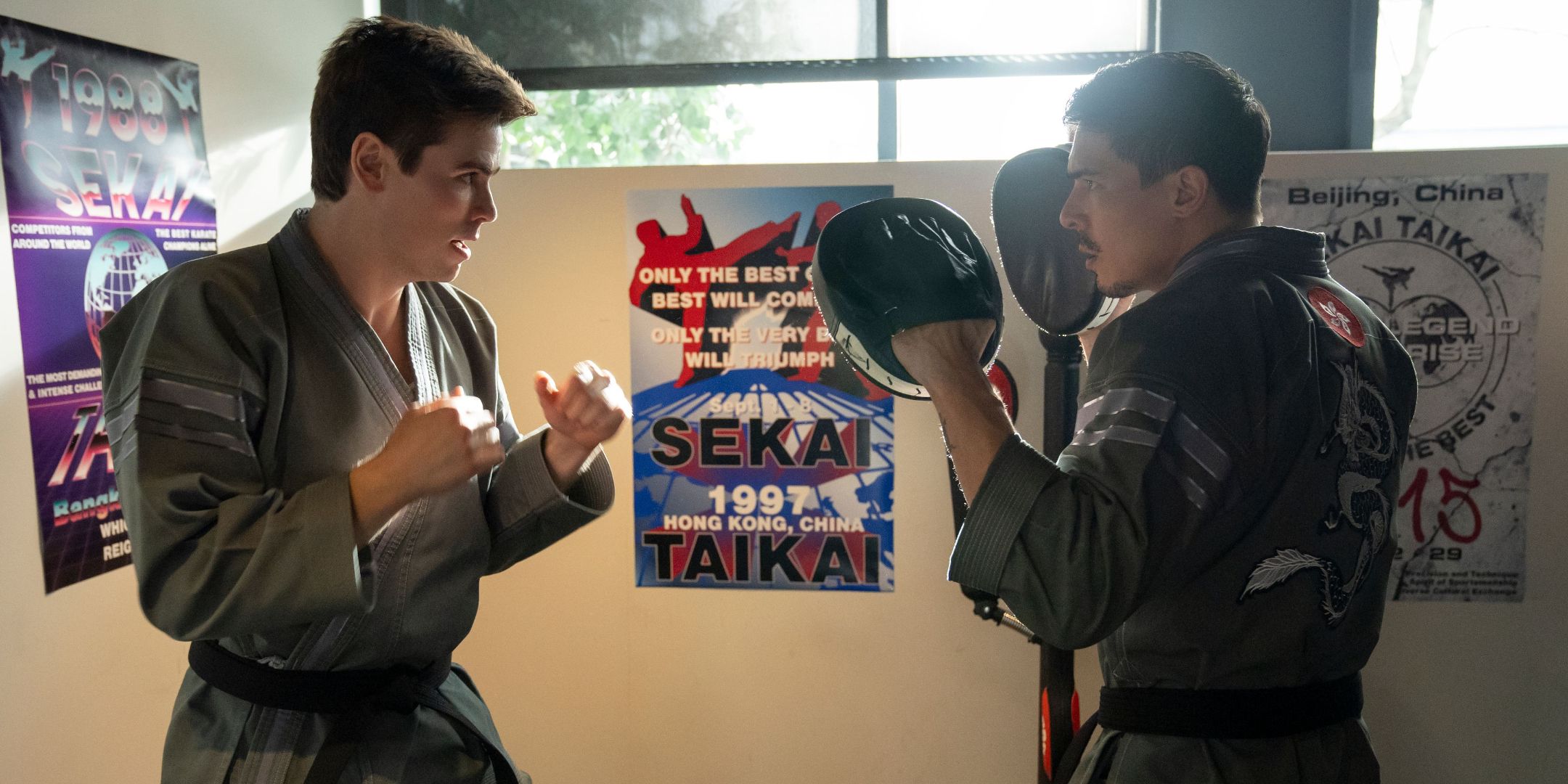 Patrick Luwin as Axel and Lewis Tan as Sensei Wolf in Cobra Kai Season 6, Part 2