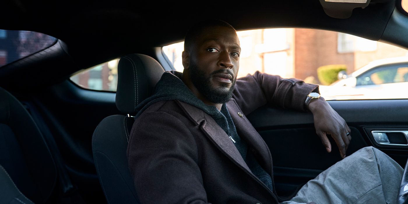 Alex Cross (Aldis Hodge) sitting in the drivers seat of a parked car