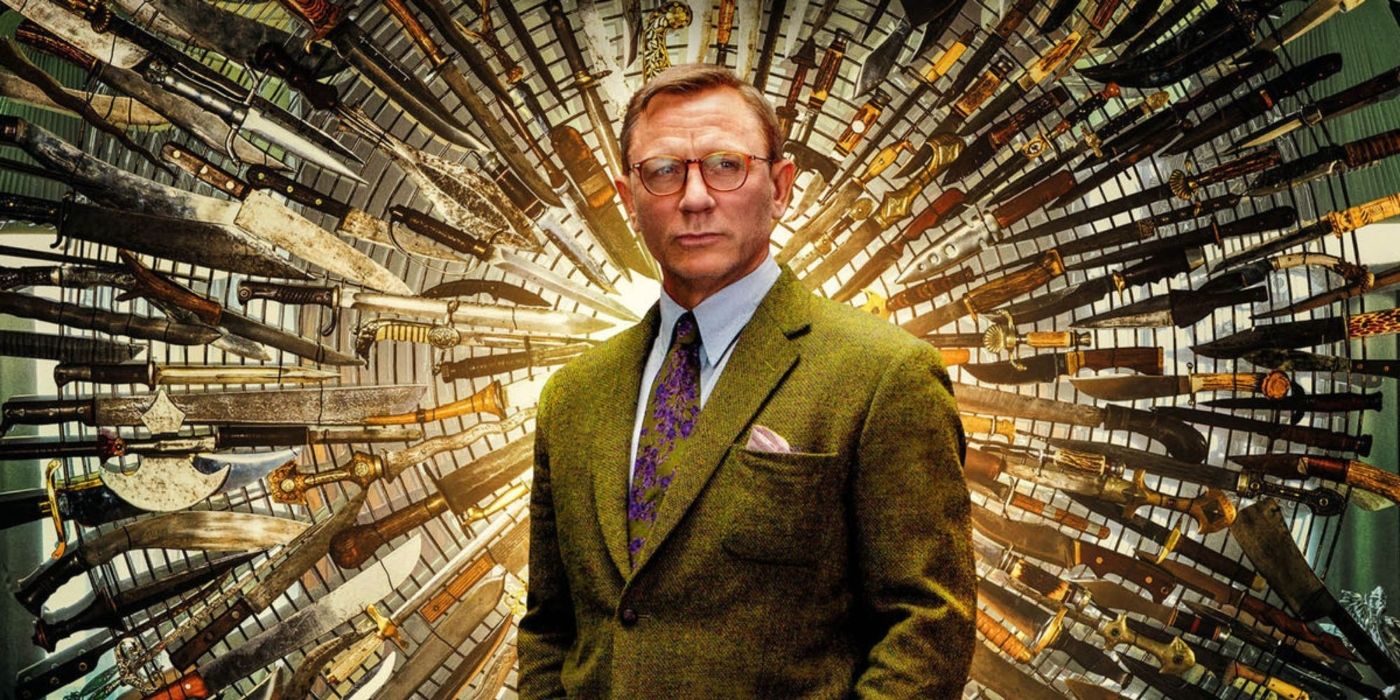 Daniel Craig as Benoit Blanc standing in front of a wall full of knives in Knives-Out