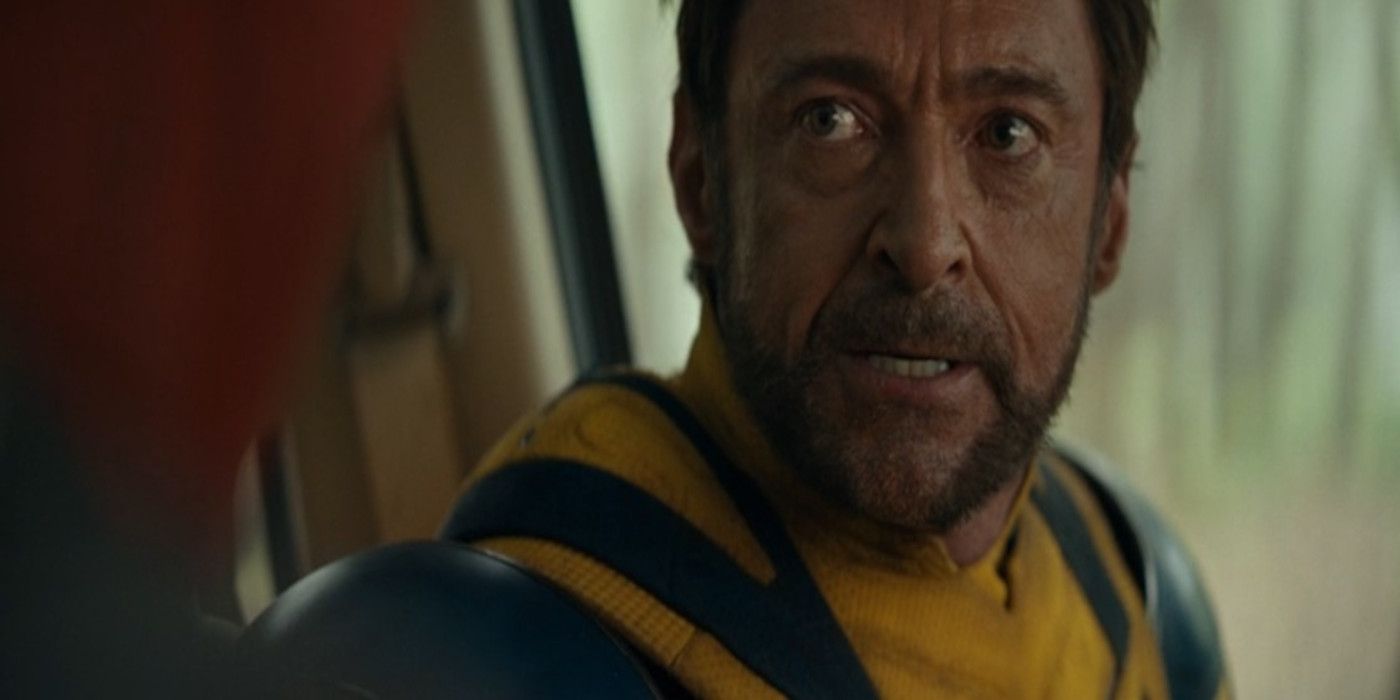 Wolverine looks at Deadpool angrily from the driver's seat of a car in Deadpool & Wolverine.