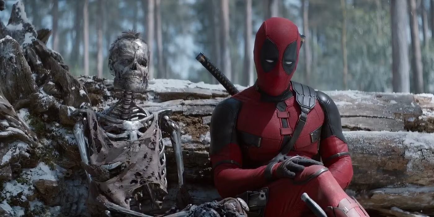 Deadpool sits next to the metal skeleton of Wolverine in a forest in Deadpool & Wolverine.