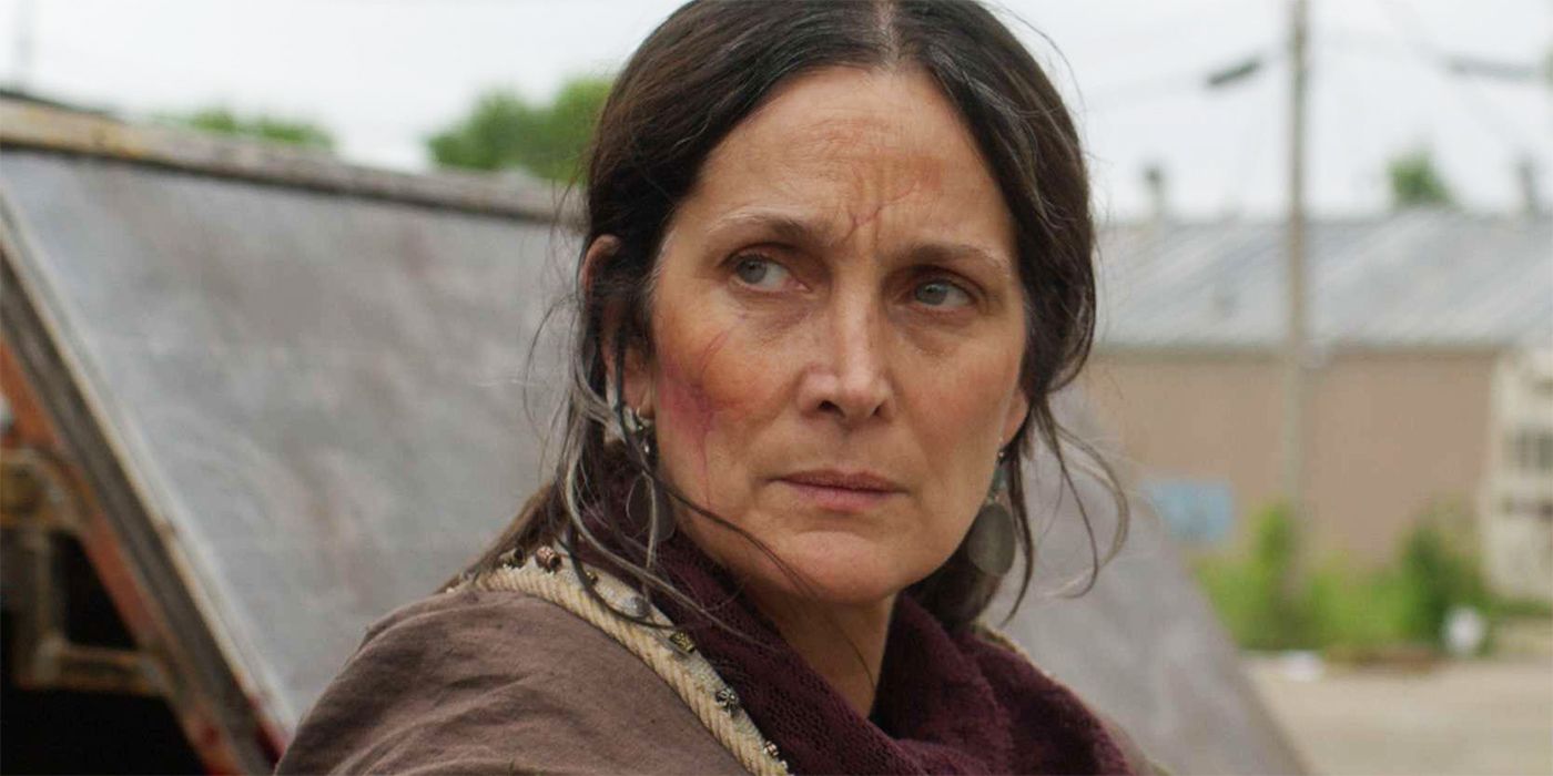 Carrie-Anne Moss as Mae with a scar on her face and looking concerned in Die Alone