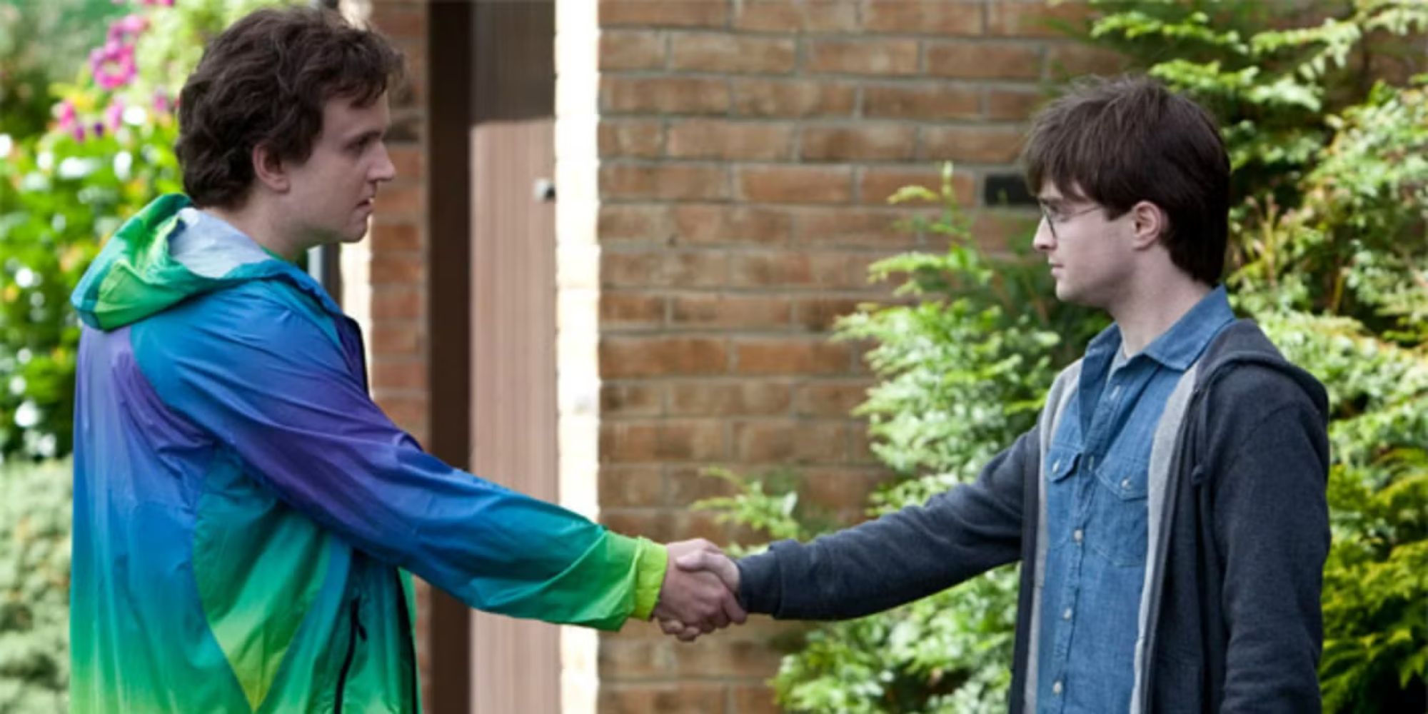 Dudley and Harry, played by actors Harry Melling and Daniel Radcliffe, shake hands in Harry Potter and the Deathly Hallows Part 1.