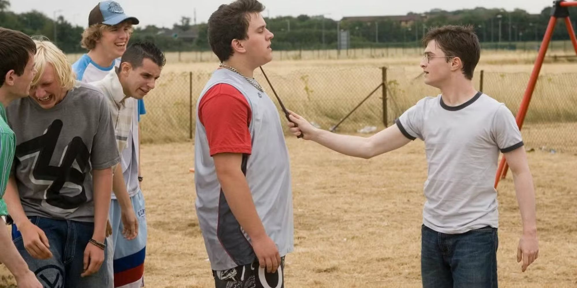Daniel Radcliffe as Harry Potter points his wand at Harry Melling as Dudley in the Order of the Phoenix.
