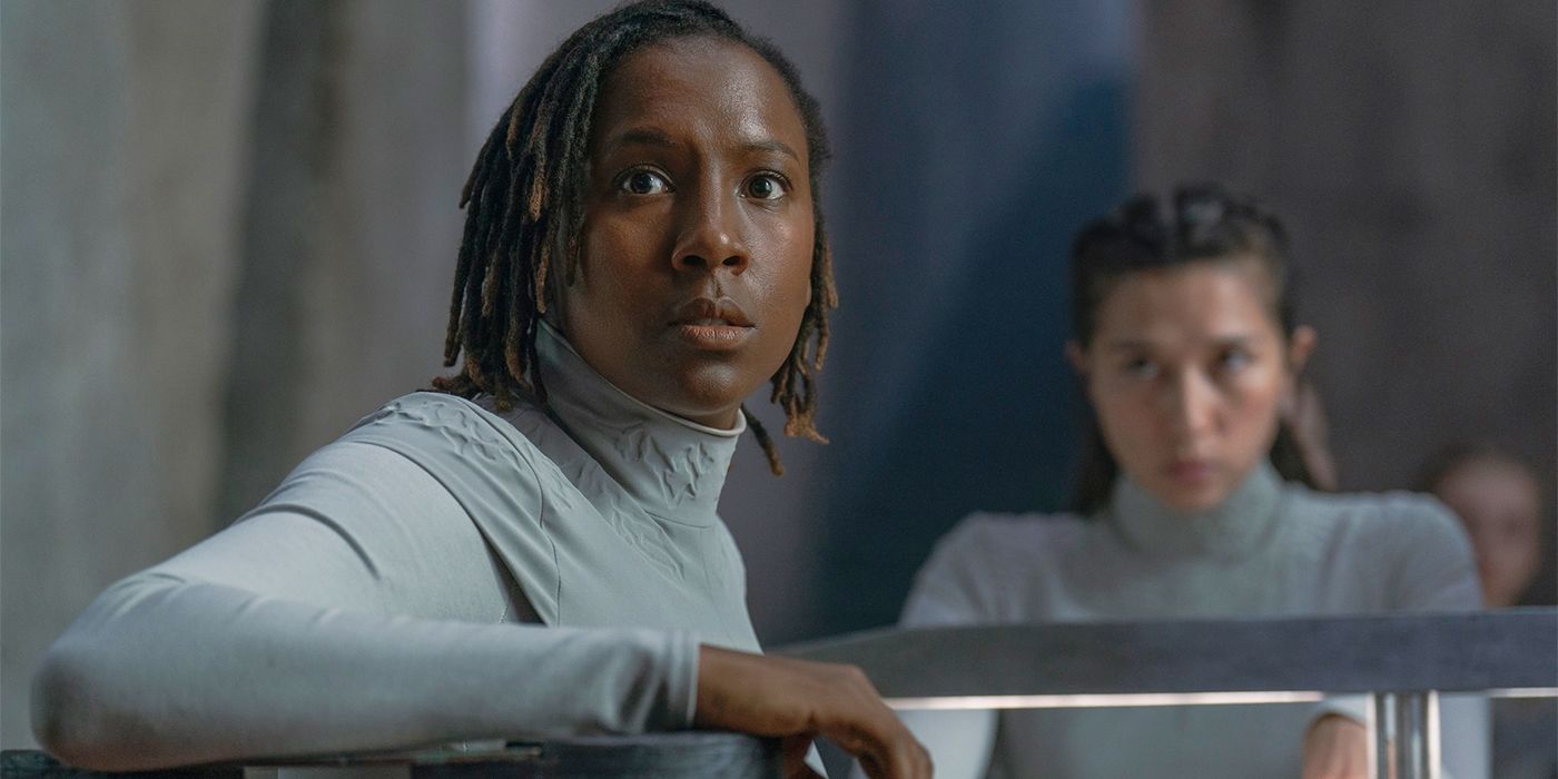 Close-up of Sister Theodosia (Jade Anouka) in her white uniform looking over her shoulder in alarm