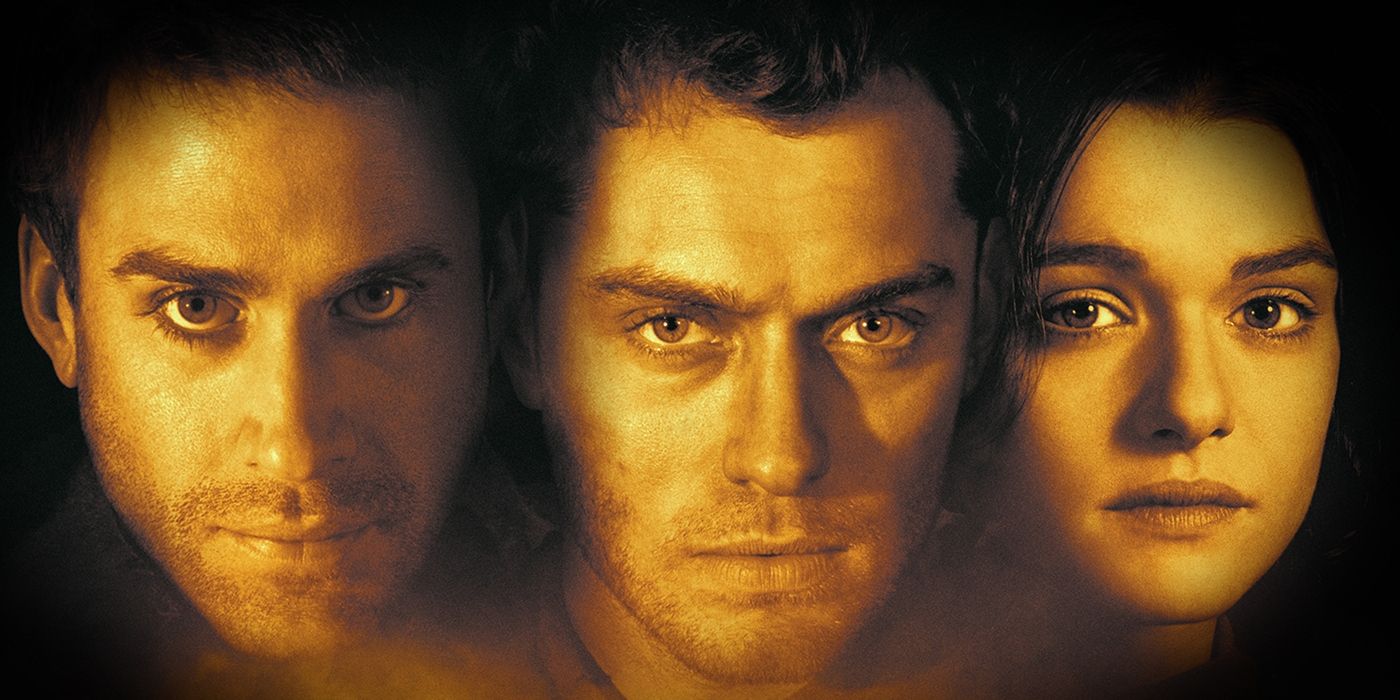 Danilov, Vassili and Tania, played by actors Joseph Fiennes, Jude Law and Rachel Weisz, looking straight forward and cast in an orange light in Enemy at the Gates.