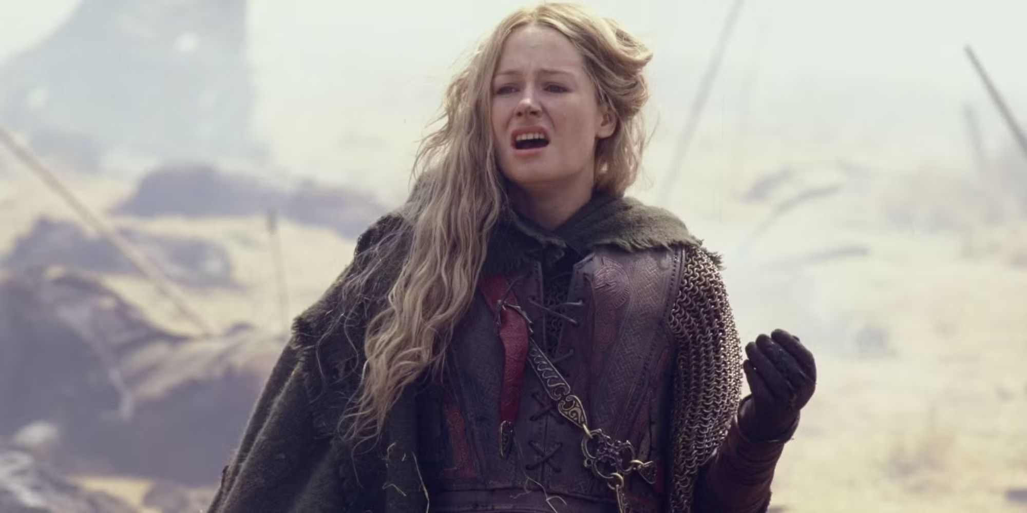 Miranda Otto as Éowyn, standing on a battlefield in The Lord of the Rings: Return of the King.