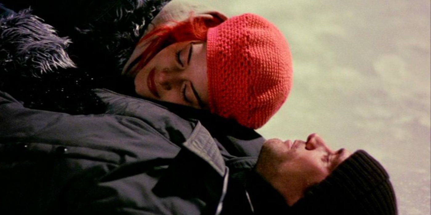 Kate Winslet and Jim Carrey lie on ice together in coats and hats in Eternal Sunshine of the Spotless Mind.