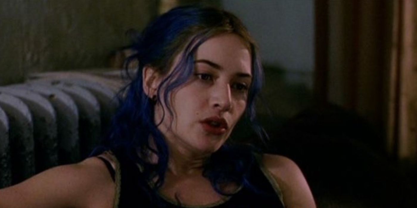 Kate Winslet as Clementine with blue hair looks melancholy in Eternal Sunshine of the Spotless Mind.