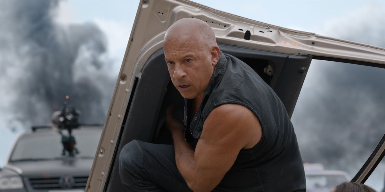 Dominic Toretto, played by Vin Diesel, shields himself behind the door of a car in &lsquo;Fast X&rsquo;.