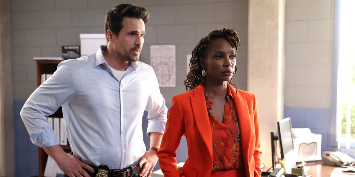 Shanola Hampton as Gabi Mosely standing in an orange suit in front of Brett Dalton in Found.