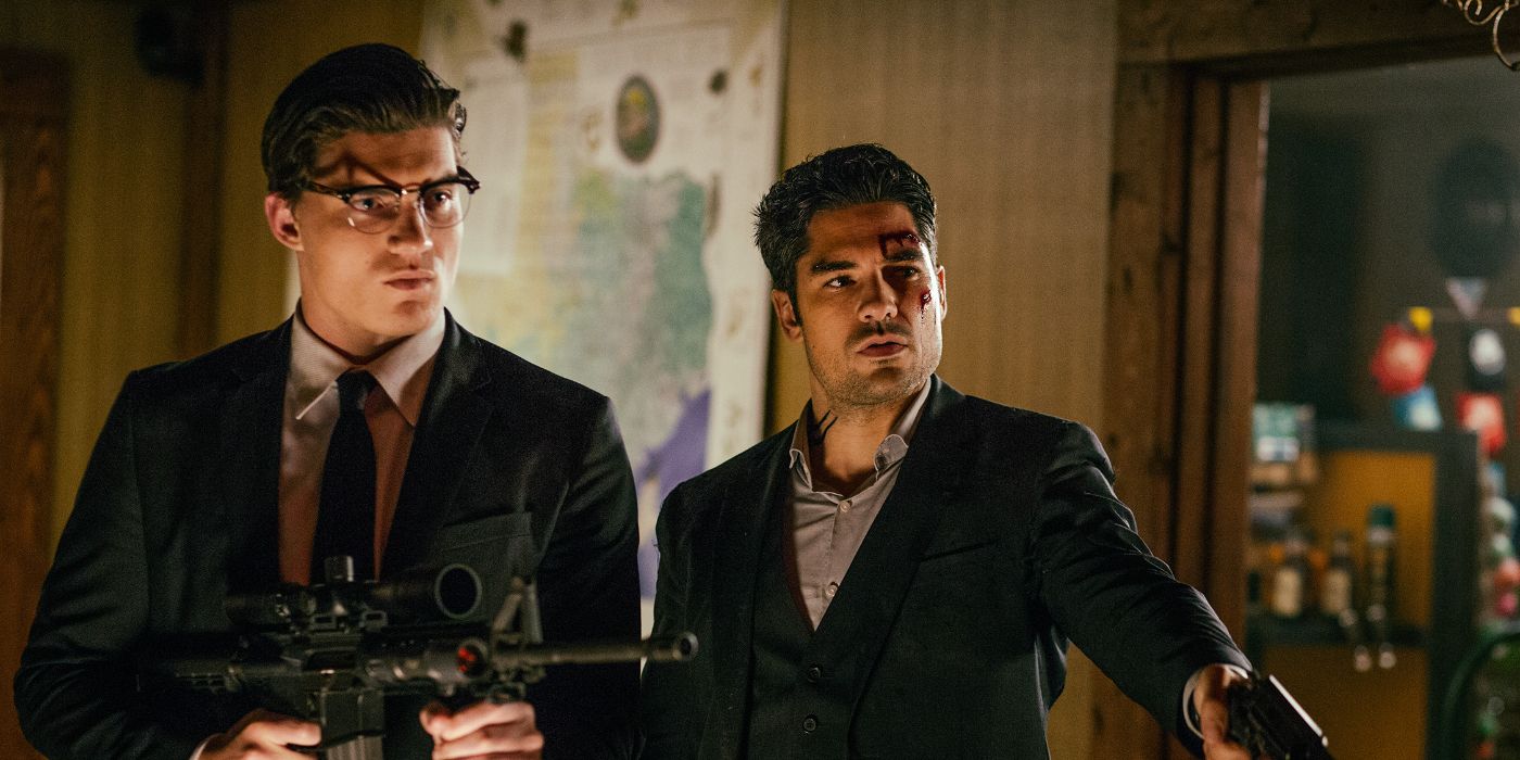 Seth Gecko (D. J. Cotrona) and Richie Gecko (Zane Holtz) looking bloody and beaten up and holding guns aimed offfscreen toward the right in From Dusk Till Dawn: The Series