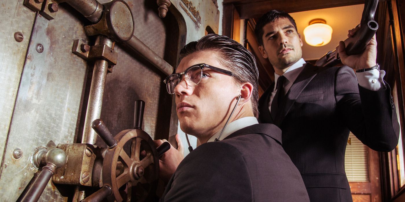 Seth Gecko (D. J. Cotrona) standing guard next to Richie Gecko (Zane Holtz) as Richie hacks a bank vault door in From Dusk Till Dawn: The Series