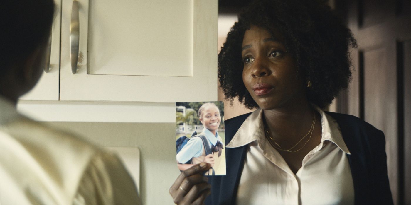 Tamara Lawrance holding up a photo of a young girl