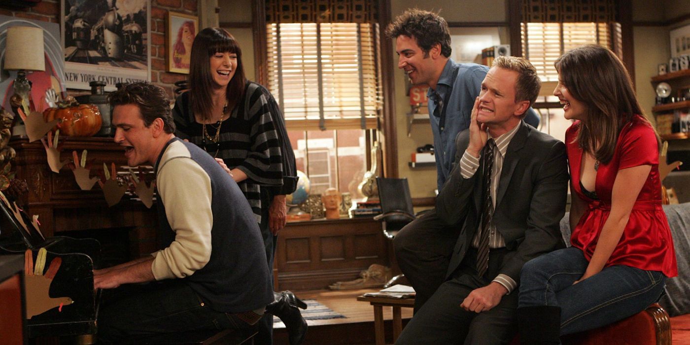 Marshall is playing his new Slapsgiving song after slapping Barney in the face and surrounded by Lily,Ted, Barney, and Robin in &lsquo;How I Met Your Mother&rsquo;