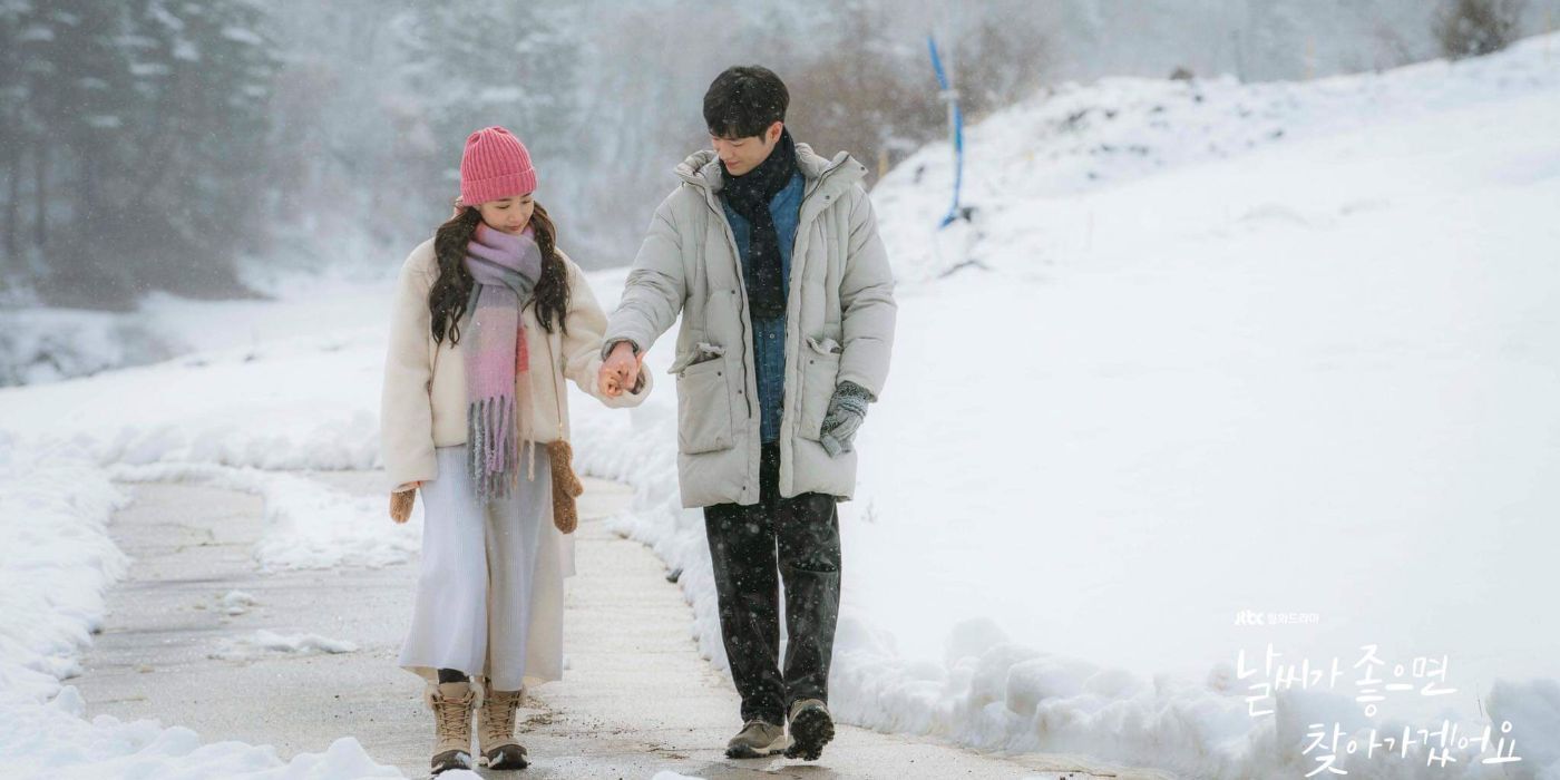 Kang Hoon & Park Min-young as Eun-seob & Hae-won walking hand-in-hand in the snow in When the Weather Is Fine